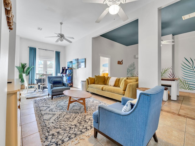 living room featuring ceiling fan, visible vents, and light tile patterned floors