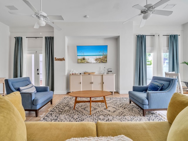 tiled living room with baseboards, a ceiling fan, and visible vents