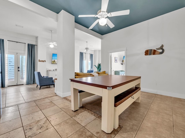 dining area featuring ceiling fan, baseboards, french doors, and light tile patterned floors