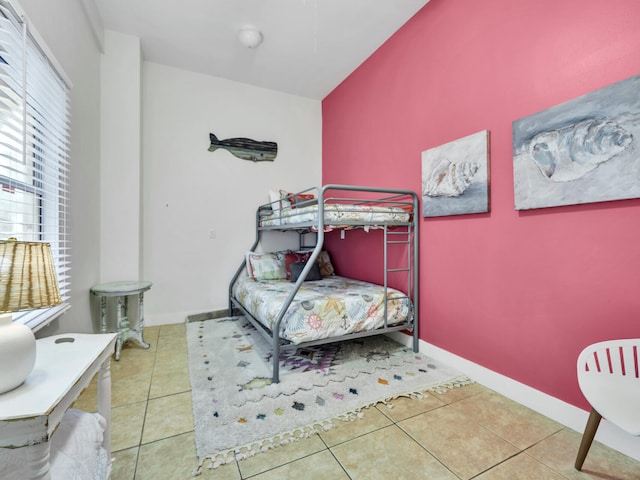bedroom featuring tile patterned floors and baseboards