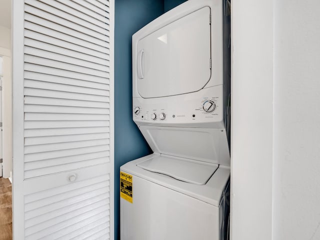 laundry area with stacked washer and dryer and laundry area