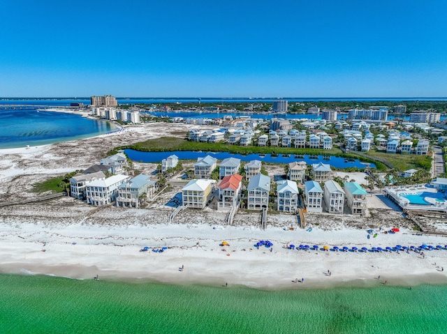 drone / aerial view featuring a beach view and a water view