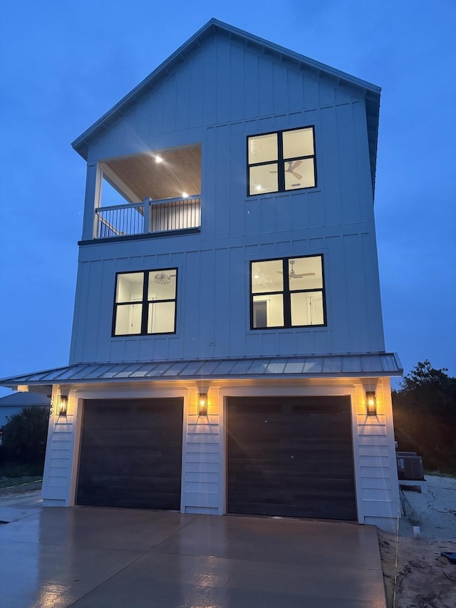162 Casting Lake Rd, Miramar Beach, FL 32550 - view of front facade with a balcony, an attached garage, a standing seam roof, and concrete driveway