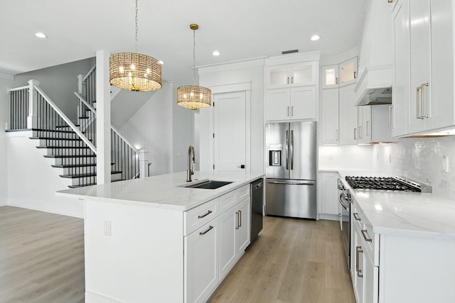 162 Casting Lake Rd, Miramar Beach, FL 32550 - kitchen with appliances with stainless steel finishes, a chandelier, custom range hood, light wood-style floors, and recessed lighting