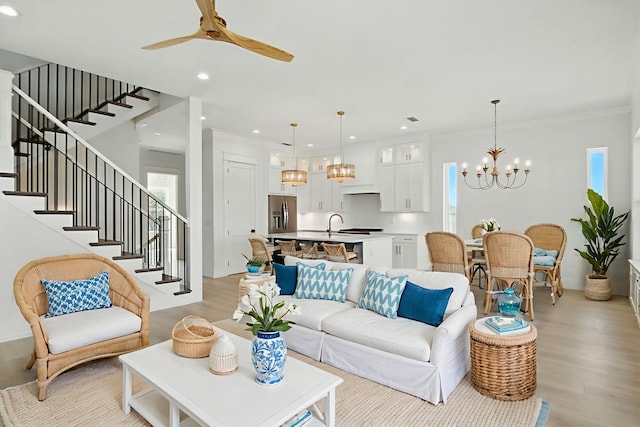 162 Casting Lake Rd, Miramar Beach, FL 32550 - living area with a chandelier, light wood-style floors, stairs, ceiling fan, and recessed lighting