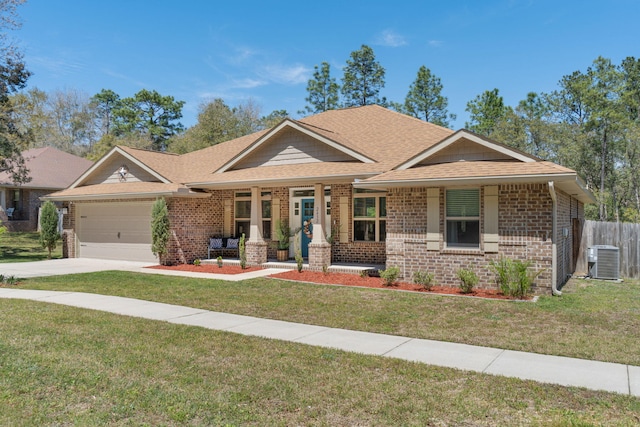 view of front of home with brick siding, a front yard, and central AC unit