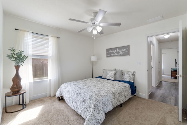 bedroom with baseboards, visible vents, carpet flooring, and a ceiling fan