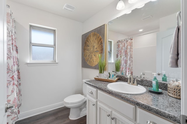 full bath with toilet, visible vents, baseboards, and wood finished floors