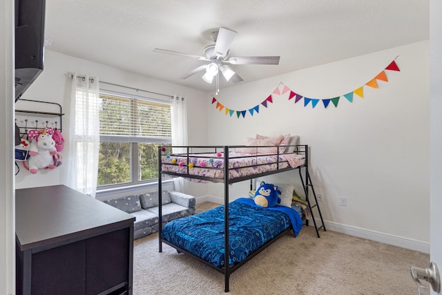carpeted bedroom featuring baseboards and a ceiling fan