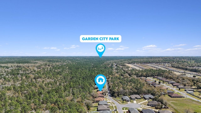 birds eye view of property with a view of trees