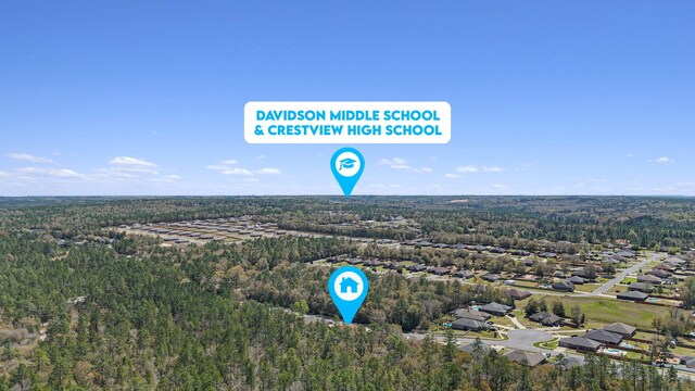 birds eye view of property featuring a wooded view