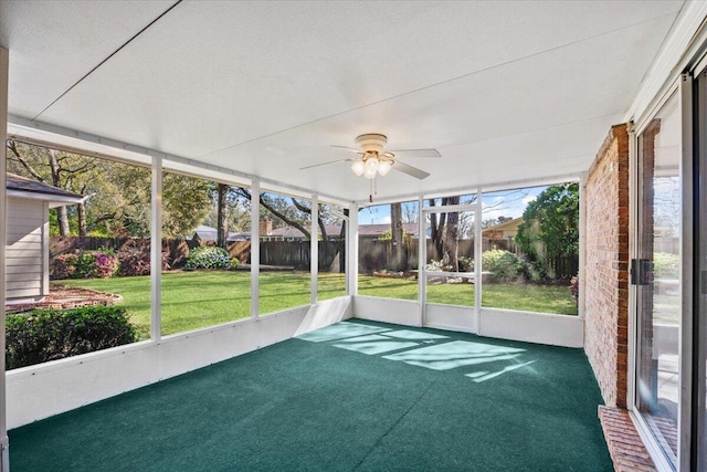 unfurnished sunroom featuring plenty of natural light and ceiling fan