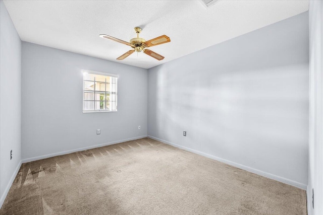 unfurnished room with baseboards, ceiling fan, and carpet flooring