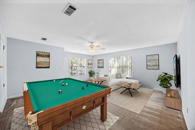 game room featuring a textured ceiling, visible vents, carpet floors, and a ceiling fan