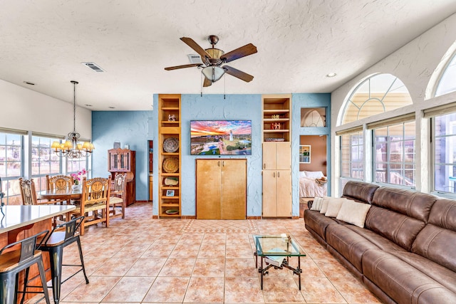 617 E E Gorrie Dr, Saint George Island, FL 32328 - living room featuring a textured ceiling, visible vents, light tile patterned floors, and built in shelves