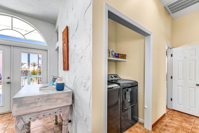617 E E Gorrie Dr, Saint George Island, FL 32328 - laundry room with tile patterned floors, washing machine and dryer, laundry area, baseboards, and visible vents