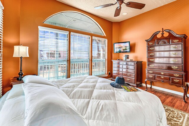 617 E E Gorrie Dr, Saint George Island, FL 32328 - bedroom featuring baseboards, a ceiling fan, wood finished floors, and a textured ceiling
