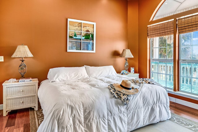 617 E E Gorrie Dr, Saint George Island, FL 32328 - bedroom with multiple windows, wood finished floors, and baseboards