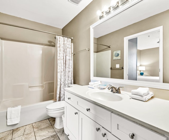 bathroom featuring toilet, vanity, tile patterned flooring, and shower / tub combo with curtain