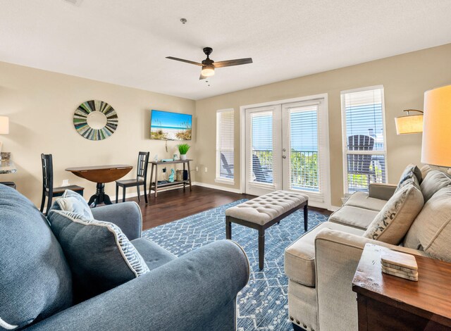 living room featuring dark wood finished floors, french doors, baseboards, and ceiling fan