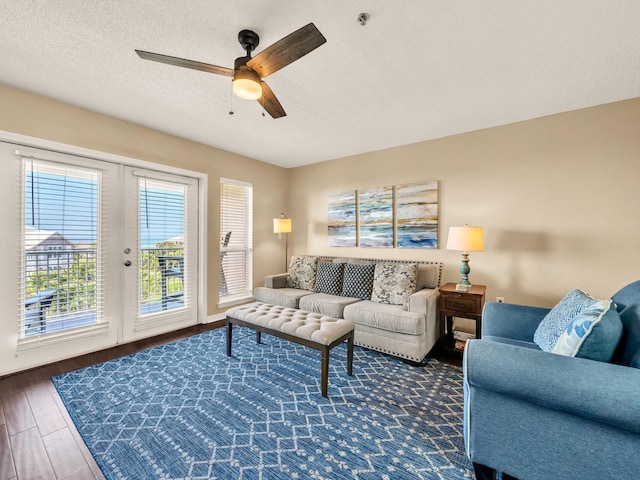 living room with a textured ceiling, wood finished floors, and ceiling fan
