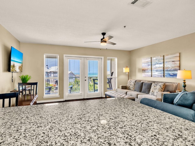 living room featuring french doors, a ceiling fan, and visible vents