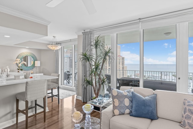 1 Beach Club Dr Unit 1205, Miramar Beach, FL 32550 - living area with wood finished floors, a water view, ornamental molding, ceiling fan, and a chandelier