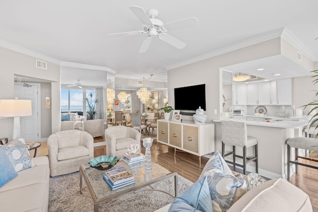 1 Beach Club Dr Unit 1205, Miramar Beach, FL 32550 - living area with ornamental molding, ceiling fan, and wood finished floors