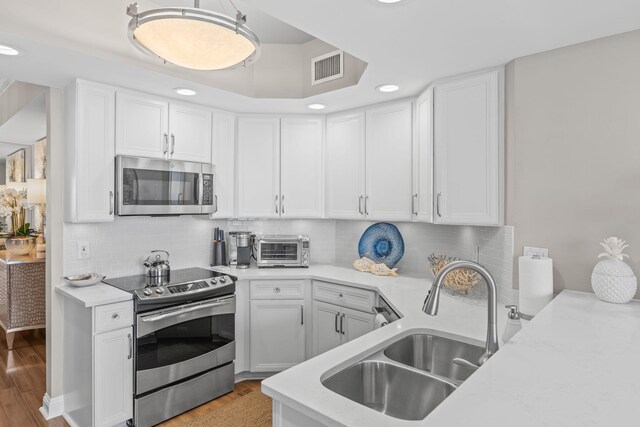 1 Beach Club Dr Unit 1205, Miramar Beach, FL 32550 - kitchen featuring appliances with stainless steel finishes, a sink, light countertops, recessed lighting, and white cabinets