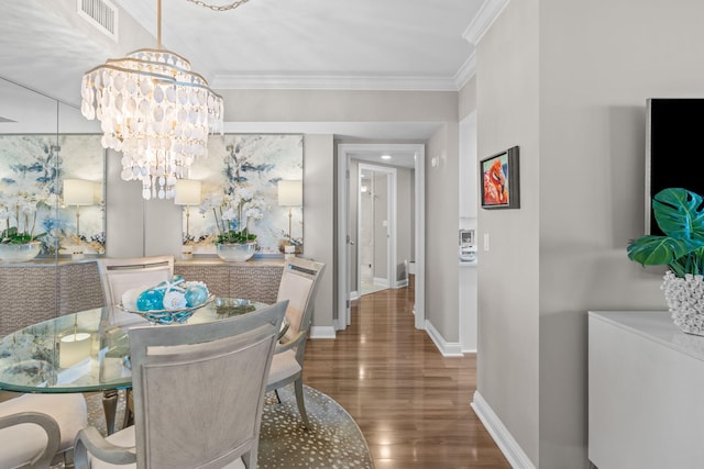 1 Beach Club Dr Unit 1205, Miramar Beach, FL 32550 - dining room with wood finished floors, a chandelier, baseboards, and crown molding