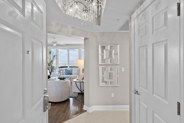 1 Beach Club Dr Unit 1205, Miramar Beach, FL 32550 - corridor featuring baseboards and a chandelier