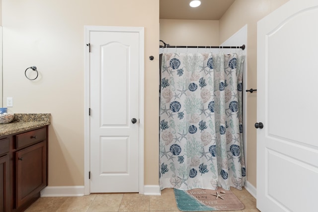 full bath with tile patterned flooring, baseboards, vanity, and curtained shower