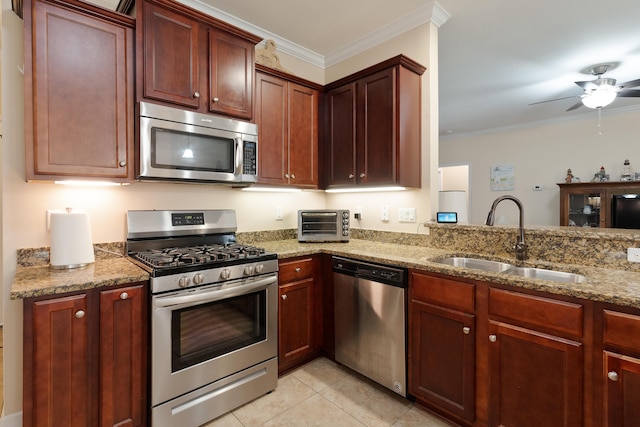 kitchen with light stone countertops, crown molding, stainless steel appliances, and a sink