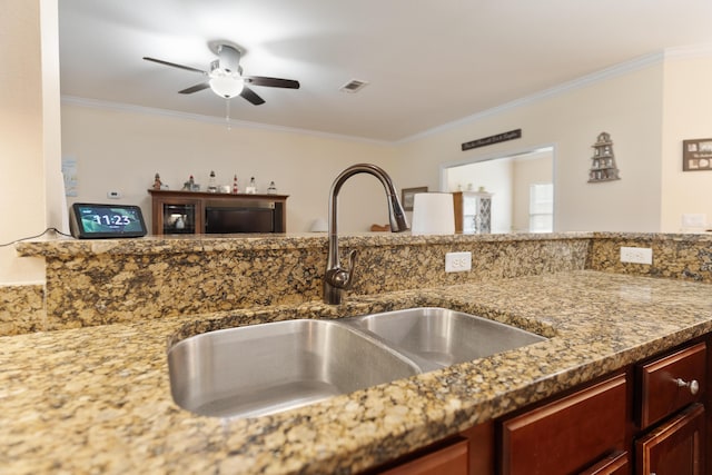 room details with visible vents, crown molding, ceiling fan, and a sink