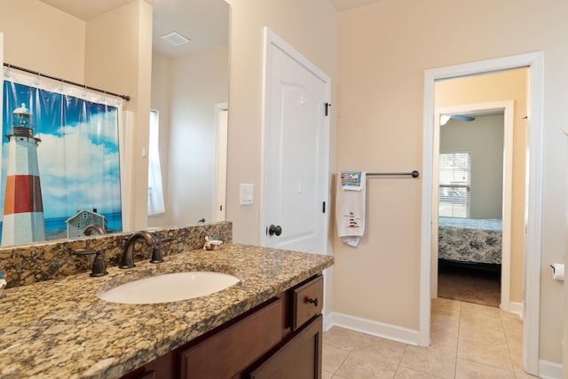 ensuite bathroom with tile patterned floors, visible vents, vanity, baseboards, and ensuite bathroom