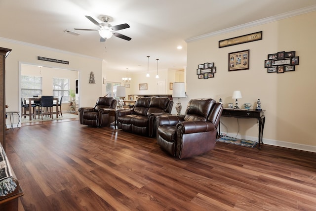 living area with wood finished floors, visible vents, crown molding, baseboards, and ceiling fan with notable chandelier