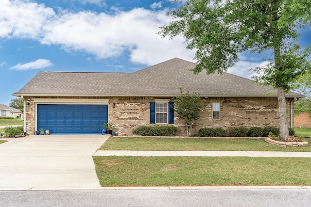 ranch-style house featuring concrete driveway, an attached garage, a front yard, brick siding, and roof with shingles