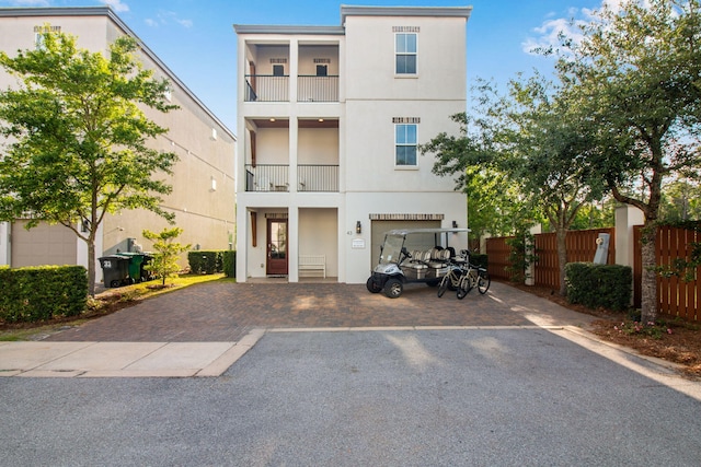 43 Calla Way, Miramar Beach, FL 32550 - view of front of home with fence, stucco siding, an attached garage, and driveway