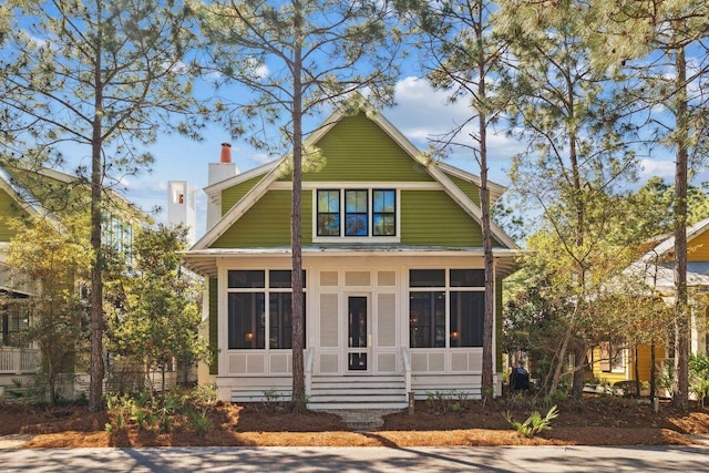76 Tall Timber Ct, Santa Rosa Beach, FL 32459 - view of front facade with a sunroom and a chimney