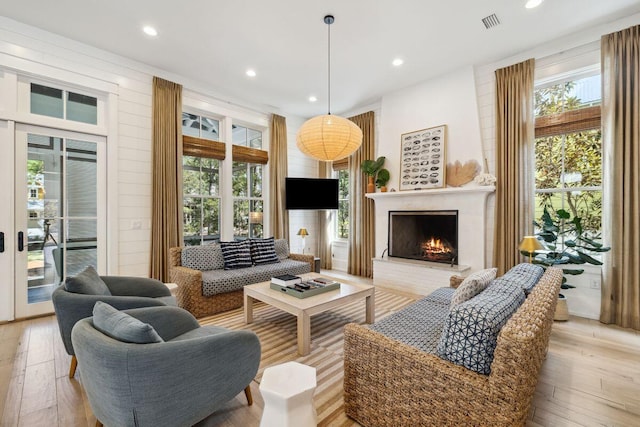 76 Tall Timber Ct, Santa Rosa Beach, FL 32459 - living area with a fireplace, a healthy amount of sunlight, and light wood finished floors