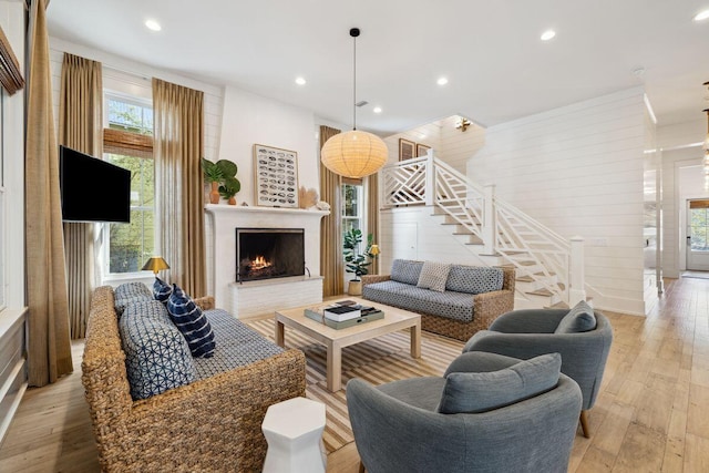 76 Tall Timber Ct, Santa Rosa Beach, FL 32459 - living area with a fireplace, recessed lighting, stairs, and light wood-type flooring