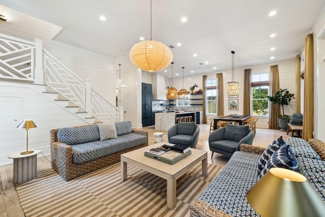 76 Tall Timber Ct, Santa Rosa Beach, FL 32459 - living room featuring wood walls, stairs, and recessed lighting