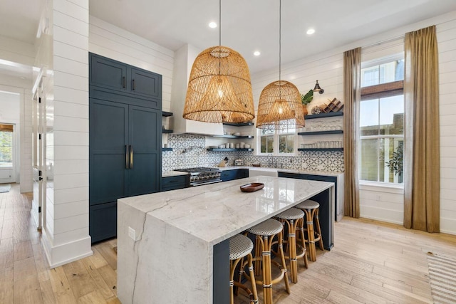 76 Tall Timber Ct, Santa Rosa Beach, FL 32459 - kitchen with a center island, light wood-type flooring, premium appliances, and open shelves