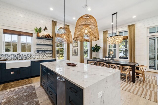 76 Tall Timber Ct, Santa Rosa Beach, FL 32459 - kitchen featuring a kitchen island, a sink, a notable chandelier, and hanging light fixtures