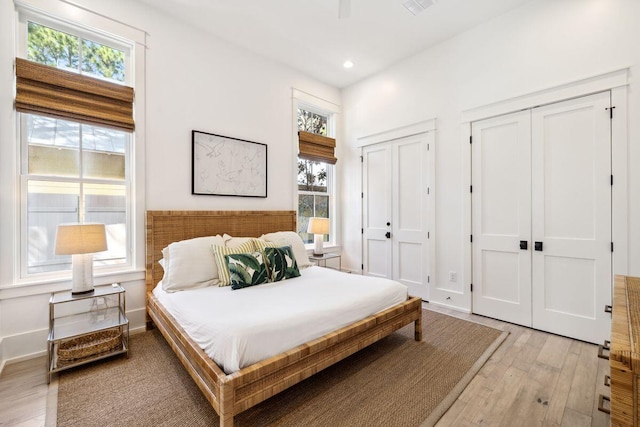 76 Tall Timber Ct, Santa Rosa Beach, FL 32459 - bedroom featuring baseboards, recessed lighting, two closets, and light wood finished floors