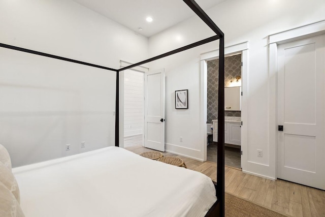 76 Tall Timber Ct, Santa Rosa Beach, FL 32459 - bedroom featuring light wood-style flooring, baseboards, ensuite bathroom, and recessed lighting