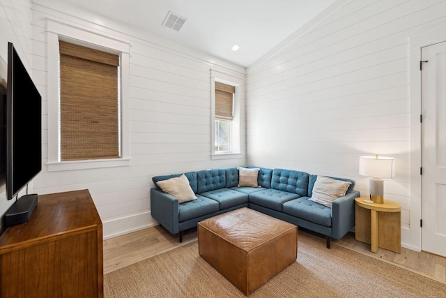 76 Tall Timber Ct, Santa Rosa Beach, FL 32459 - living area with baseboards, vaulted ceiling, visible vents, and light wood-style flooring