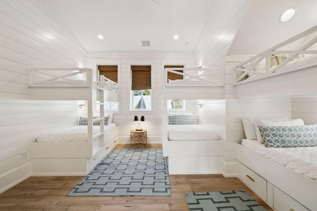 76 Tall Timber Ct, Santa Rosa Beach, FL 32459 - unfurnished bedroom featuring visible vents, wood finished floors, lofted ceiling, and recessed lighting