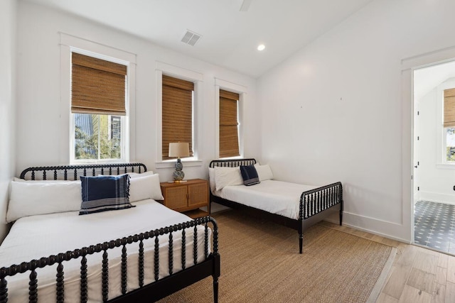 76 Tall Timber Ct, Santa Rosa Beach, FL 32459 - bedroom with visible vents, baseboards, recessed lighting, light wood-style floors, and vaulted ceiling