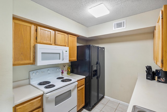 4000 Dancing Cloud Ct Unit 15, Destin, FL 32541 - kitchen featuring white appliances, light tile patterned floors, light countertops, visible vents, and a textured ceiling